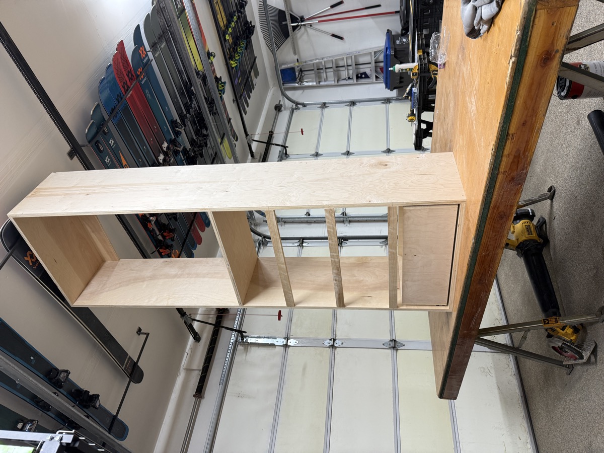 Plywood shelving tower being assembled on the workbench in the shop