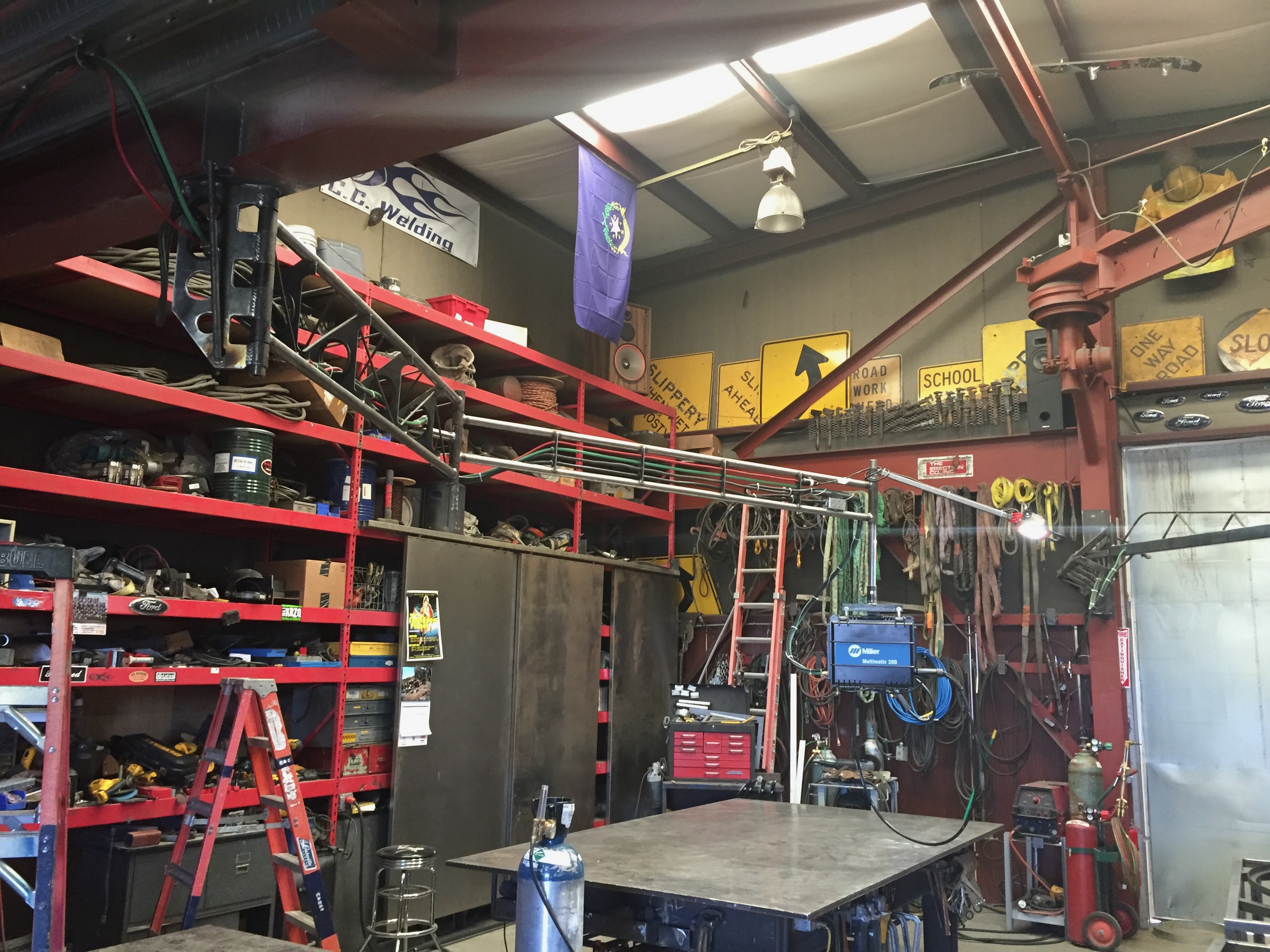 CC Welding shop interior with Miller welders and steel table