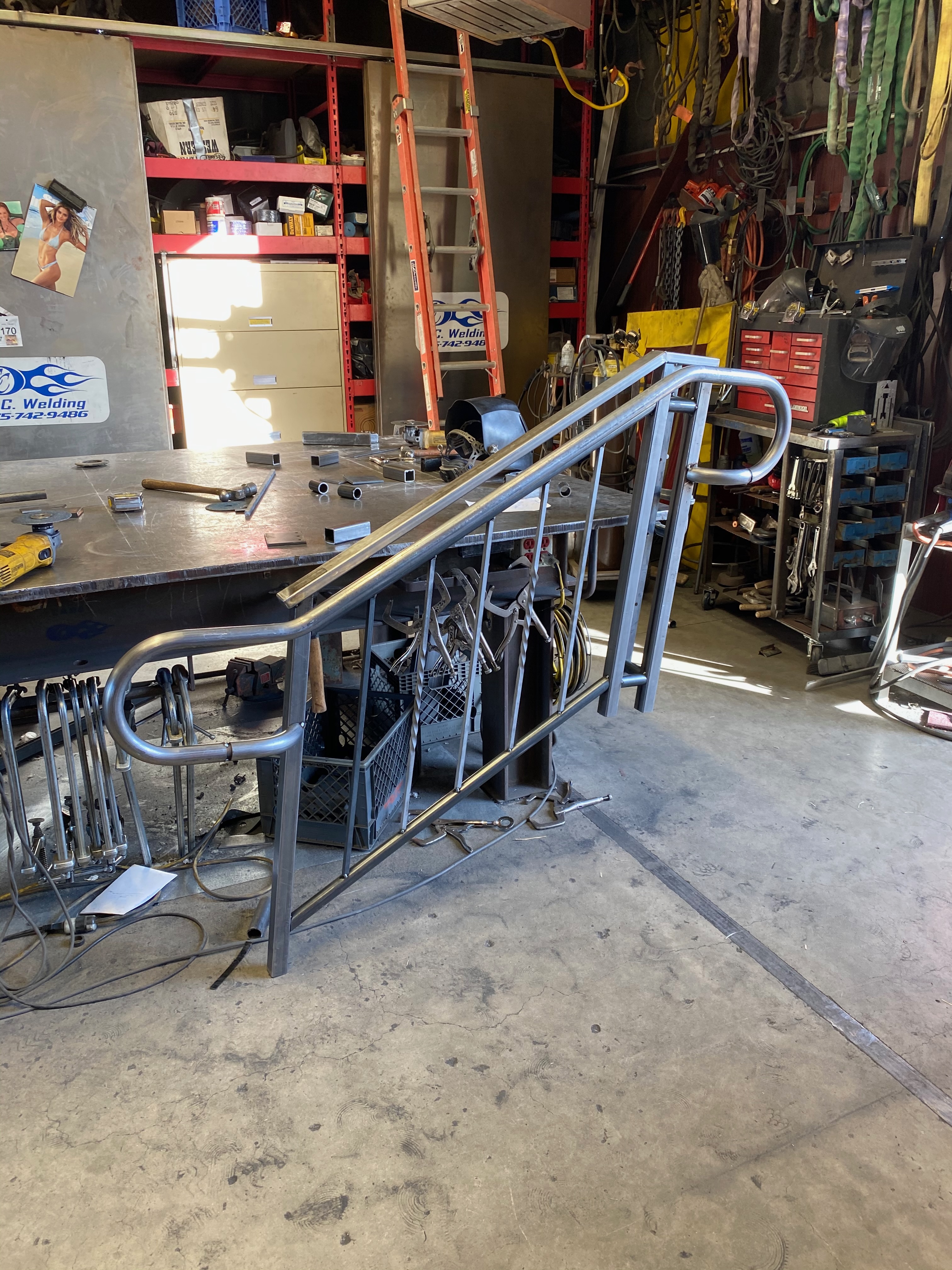 Steel stair railing with curved handrail